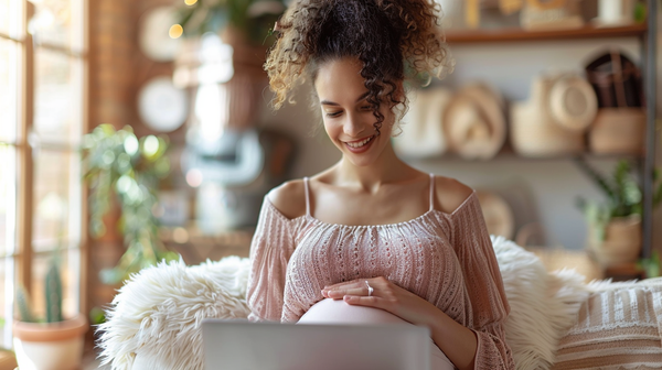 pregnant woman researching how to care for maternity lingerie on laptop