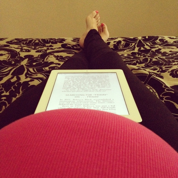 [Bump Style Approved: Pregnancy Style Q&A with Anabell Ingleton] - [Anabell Ingleton Showing bump while reading]