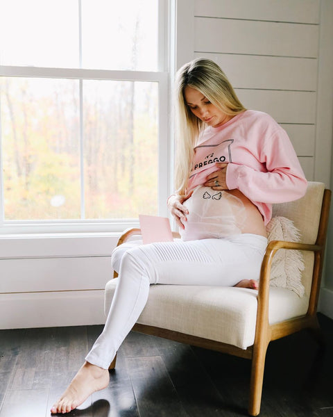 [#BumpStyleApproved: Mama Cassie Shows Off Her White Maternity Leggings] - {Cassie wearing White Out Moto Leggings and Pink Maternity Sweatshirt]