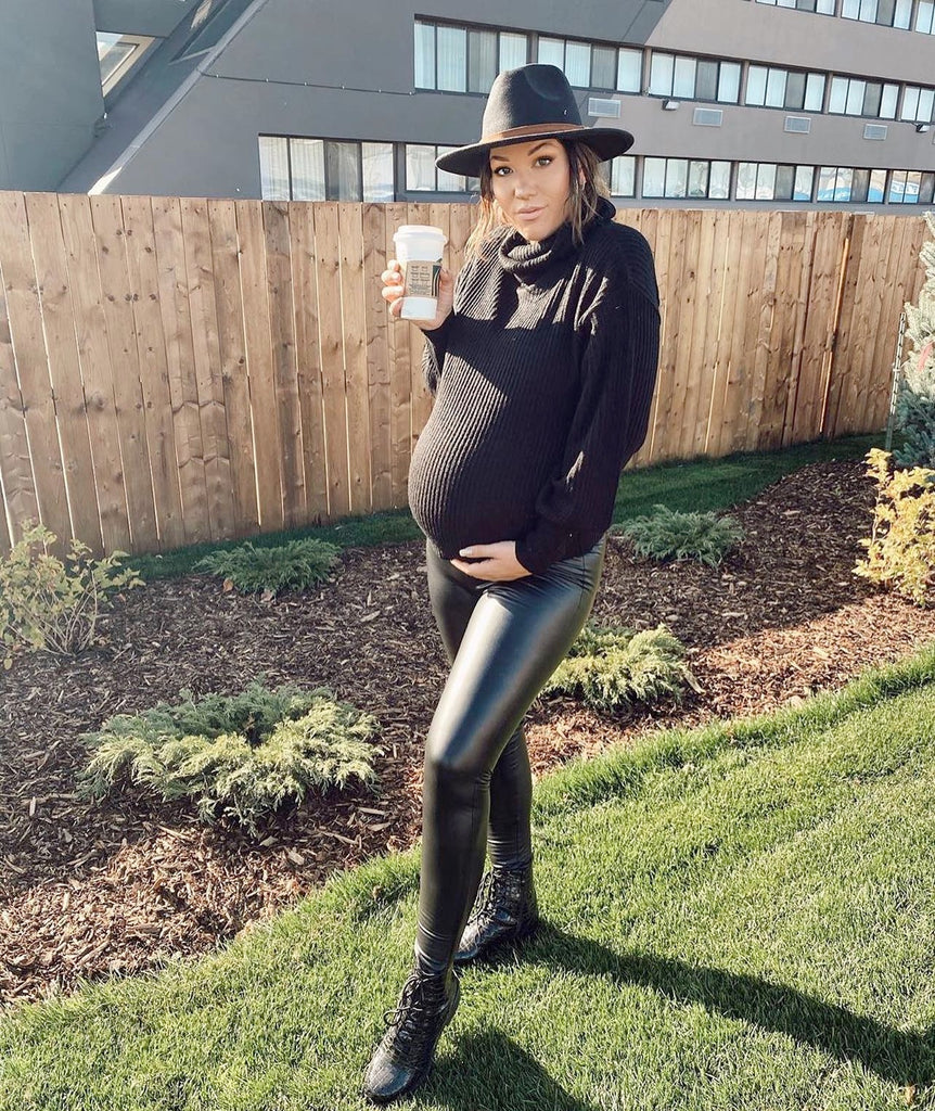 pregnant woman wearing faux leather maternity leggings