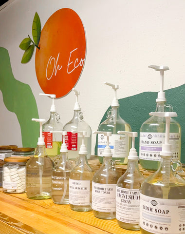 Glass bottles with pumps and logo of Oh Eco