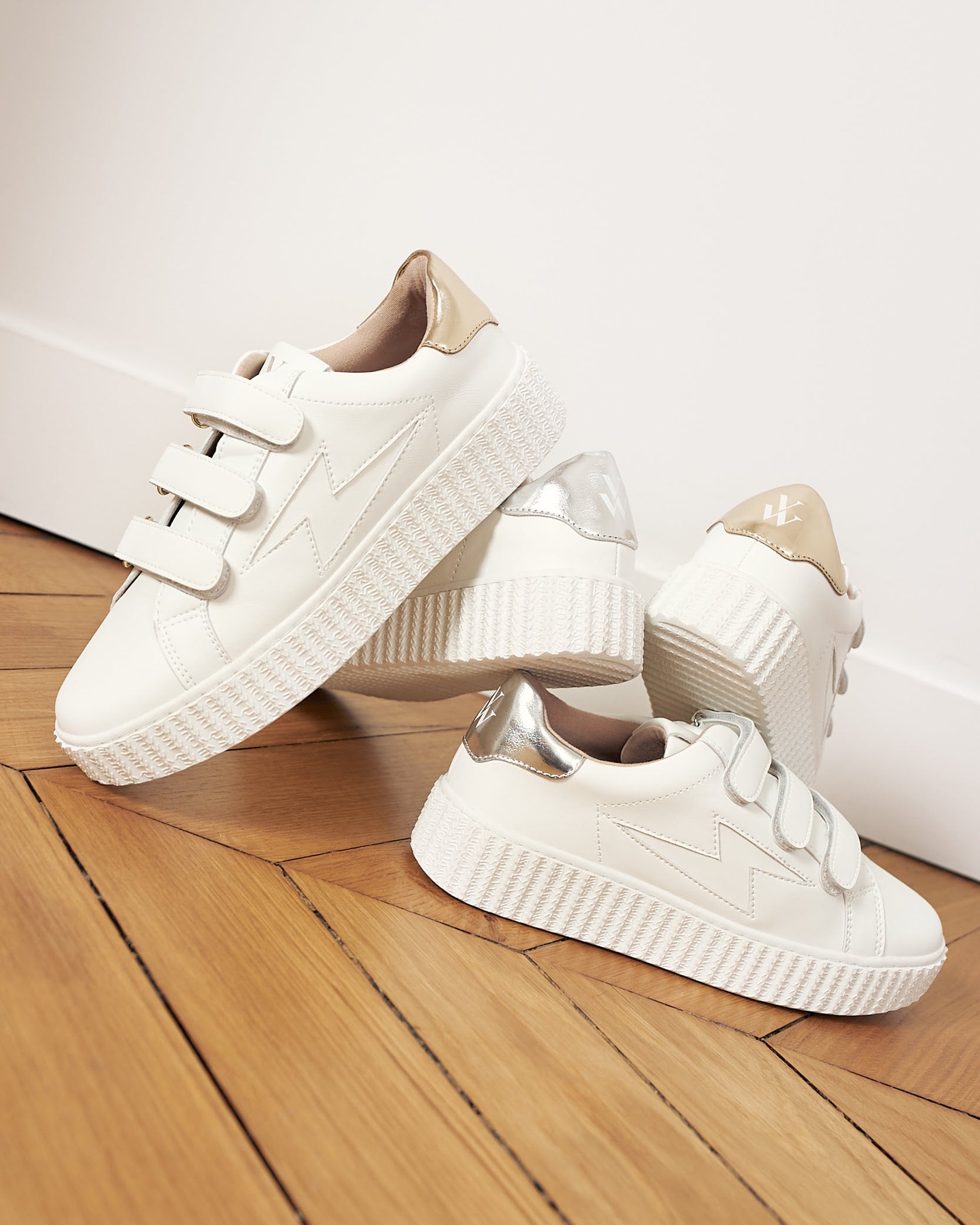 Maria white storm sneakers with gold and silver velcro.