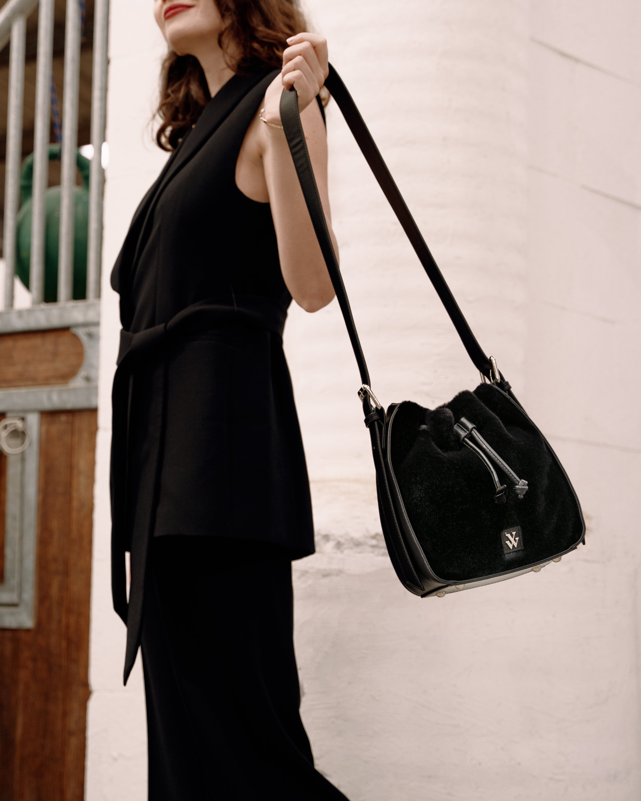 Young woman wearing the black Gladis faux fur purse by Vanessa Wu.