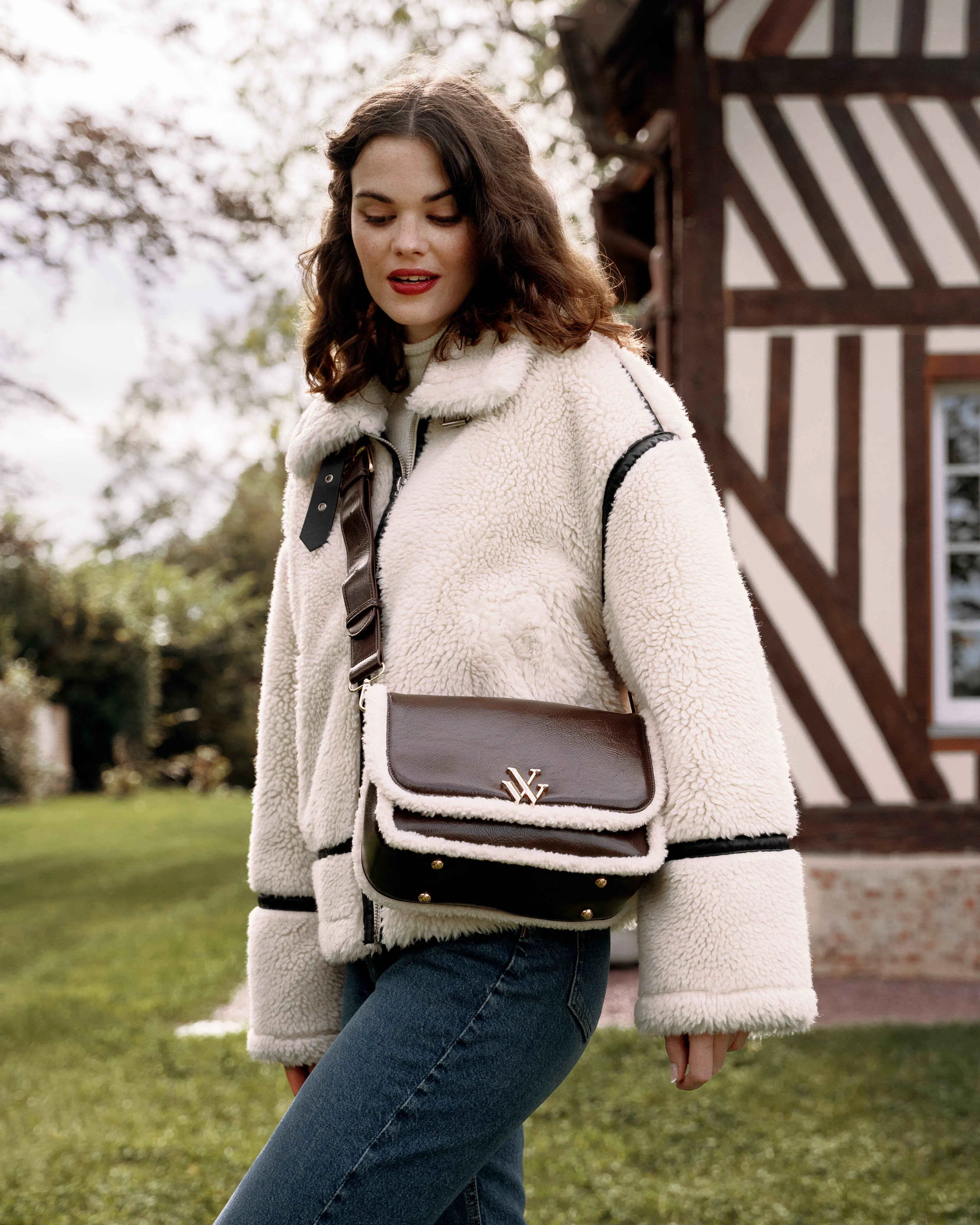 Young woman wearing the brown Bertina shoulder handbag with flap and faux shearling by Vanessa Wu