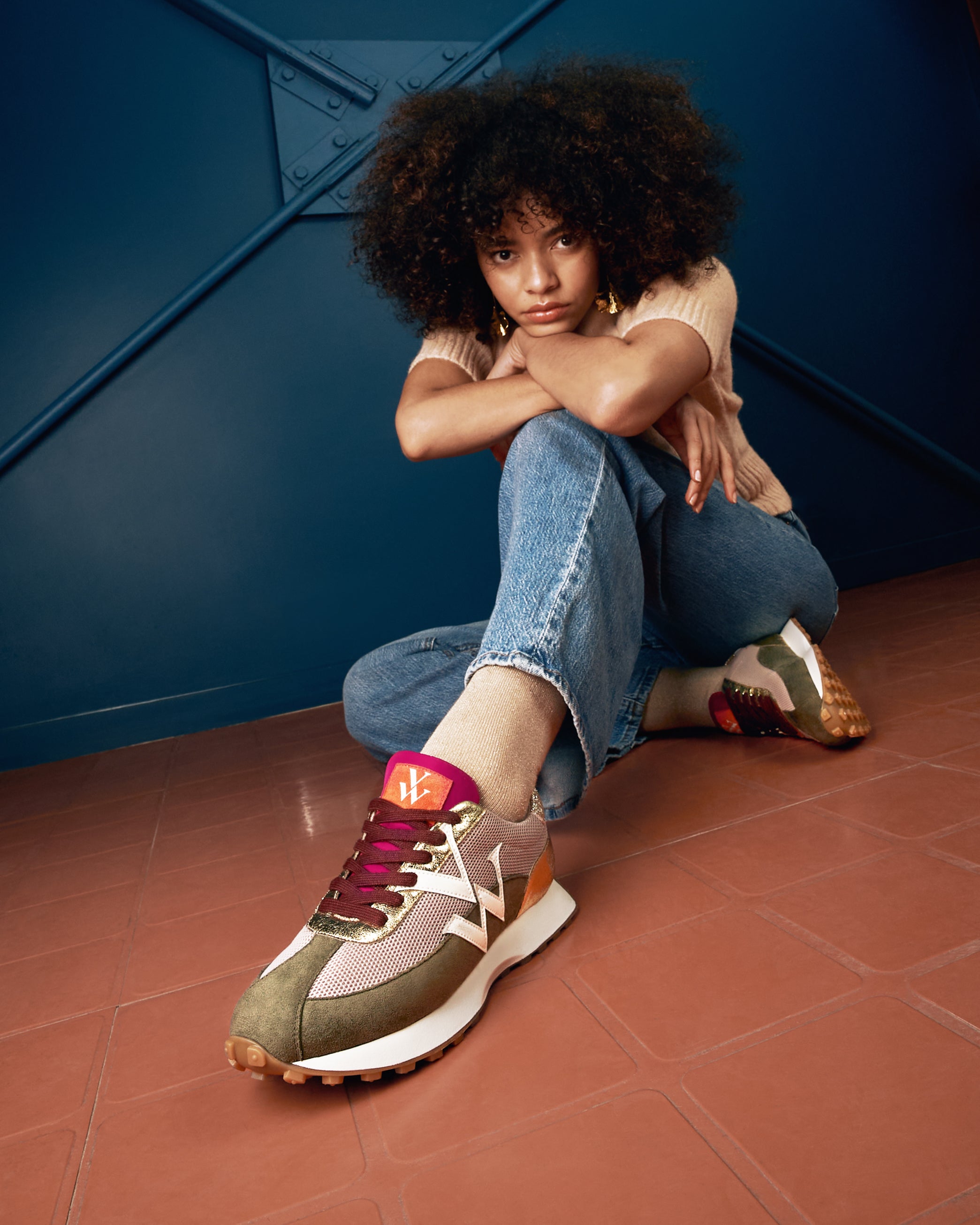 Young woman wearing the Faustine beige and green khaki monogram sneakers with running sole by Vanessa Wu