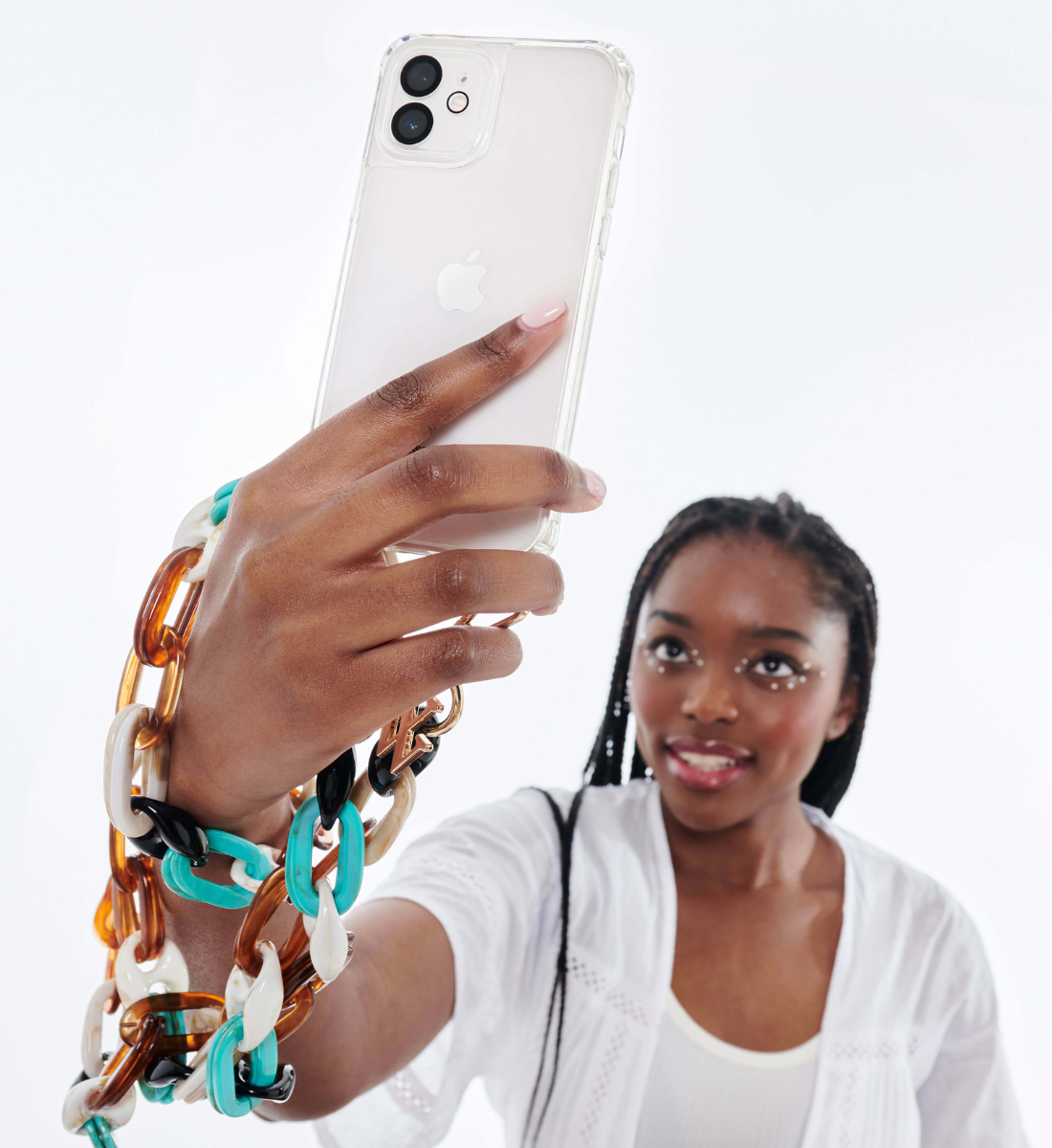 Young woman holding her phone with the Noemie multicolor phone chain by Vanessa Wu.