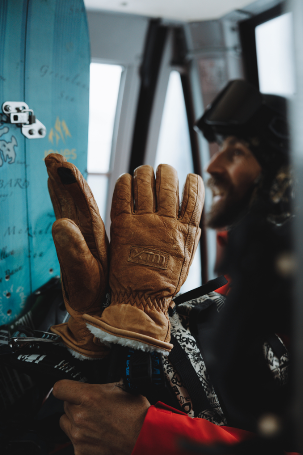 Pair of snow gloves sit on ski poles inside Monterosa Gondola