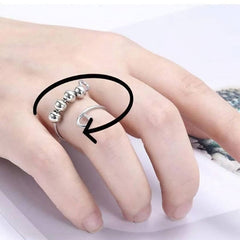 Stainless steel silver beaded ring for anxiety on a woman's finger