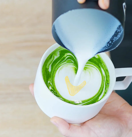 The final step of creating a tulip with matcha latte art