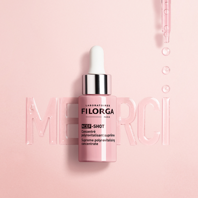 NCEF-SHOT bottle with merci written in serum behind it