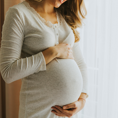 woman cradling her pregnant belly