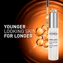 FILORGA HYDRA-AOX [5] - Younger looking skin for longer with bottle and dropper on orange background