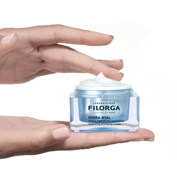 Hands holding open jar of FILORGA HYRA-HYAL CREAM