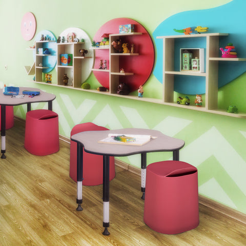 red stackable dott stools in an early education classroom next to school desks