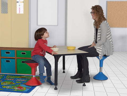 red grow stool in an early education classroom with a student and teacher