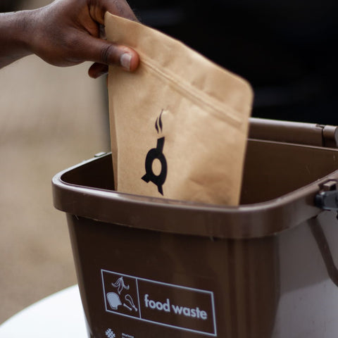 coffee bag going into food waste bin