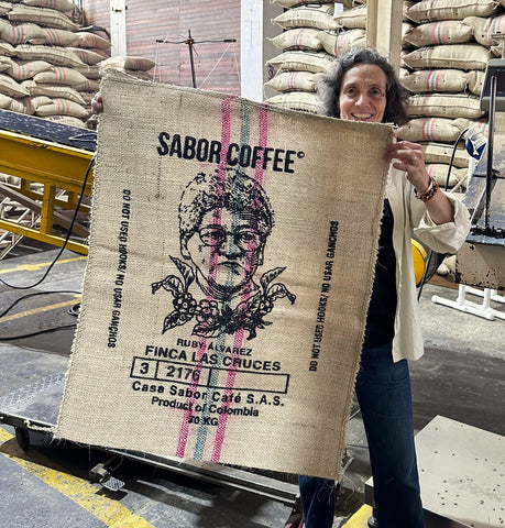 lady holding coffee sack with womans face on it