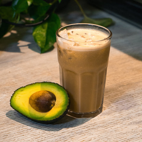 avocado coffee with half an avocado next to it