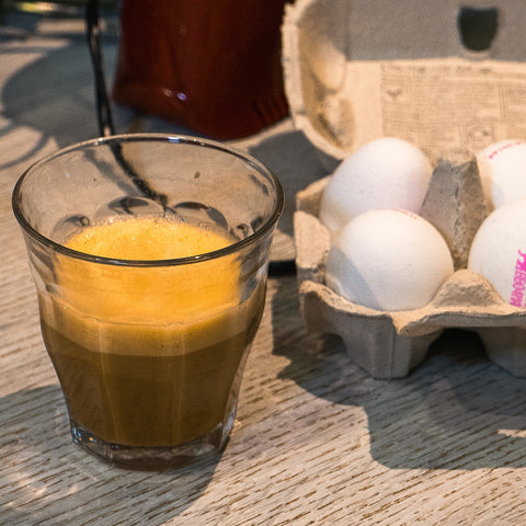 vietnamese egg coffee with box of eggs in the background