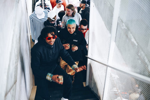 Group of people climbing stairs after the launch party of the pop-up shop