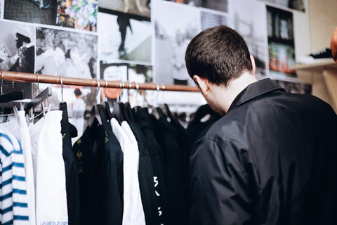 Man browsing the POP Trading Company clothing collection