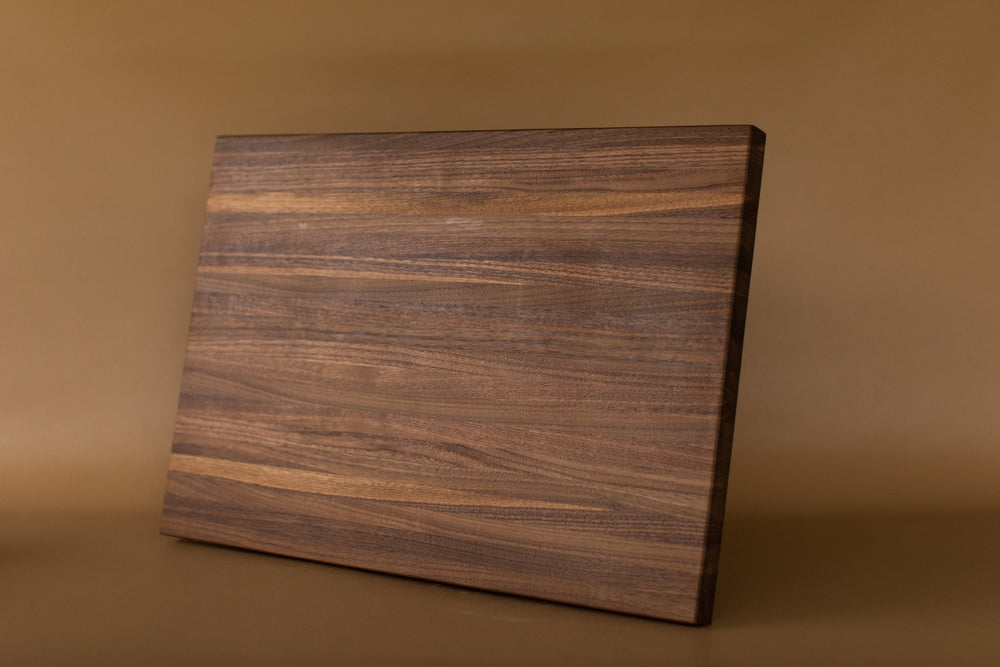 https://cdn.shopify.com/s/files/1/0557/2732/5342/products/walnut-cutting-board-16-x-23-383474_1000x1000.jpg?v=1687392420