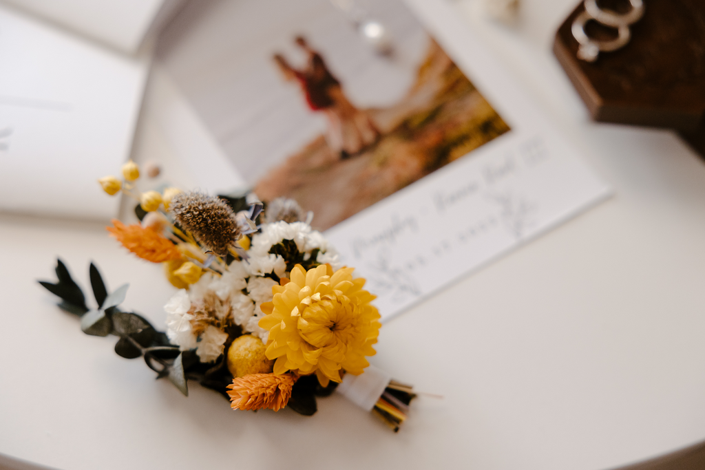 A photo shows a small yellow bunch of dried flowers for wedding decorations.
