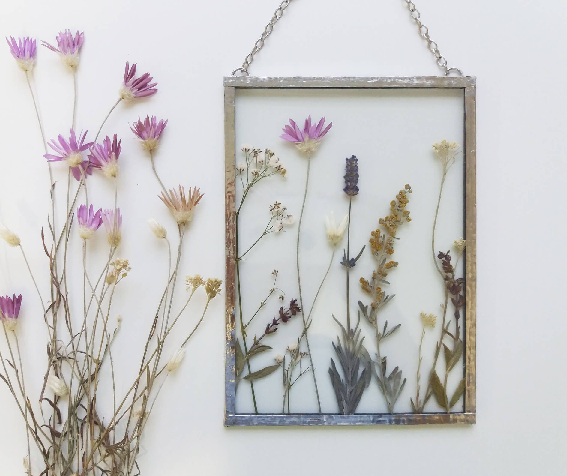 Framed dried flower art with dried wildflowers.