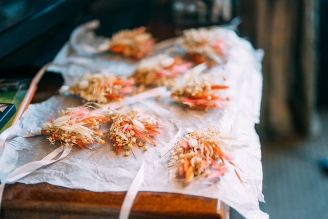 Pink, orange, and beige dried flower arrangements, handmade from Hidden Botanics wedding decorations.