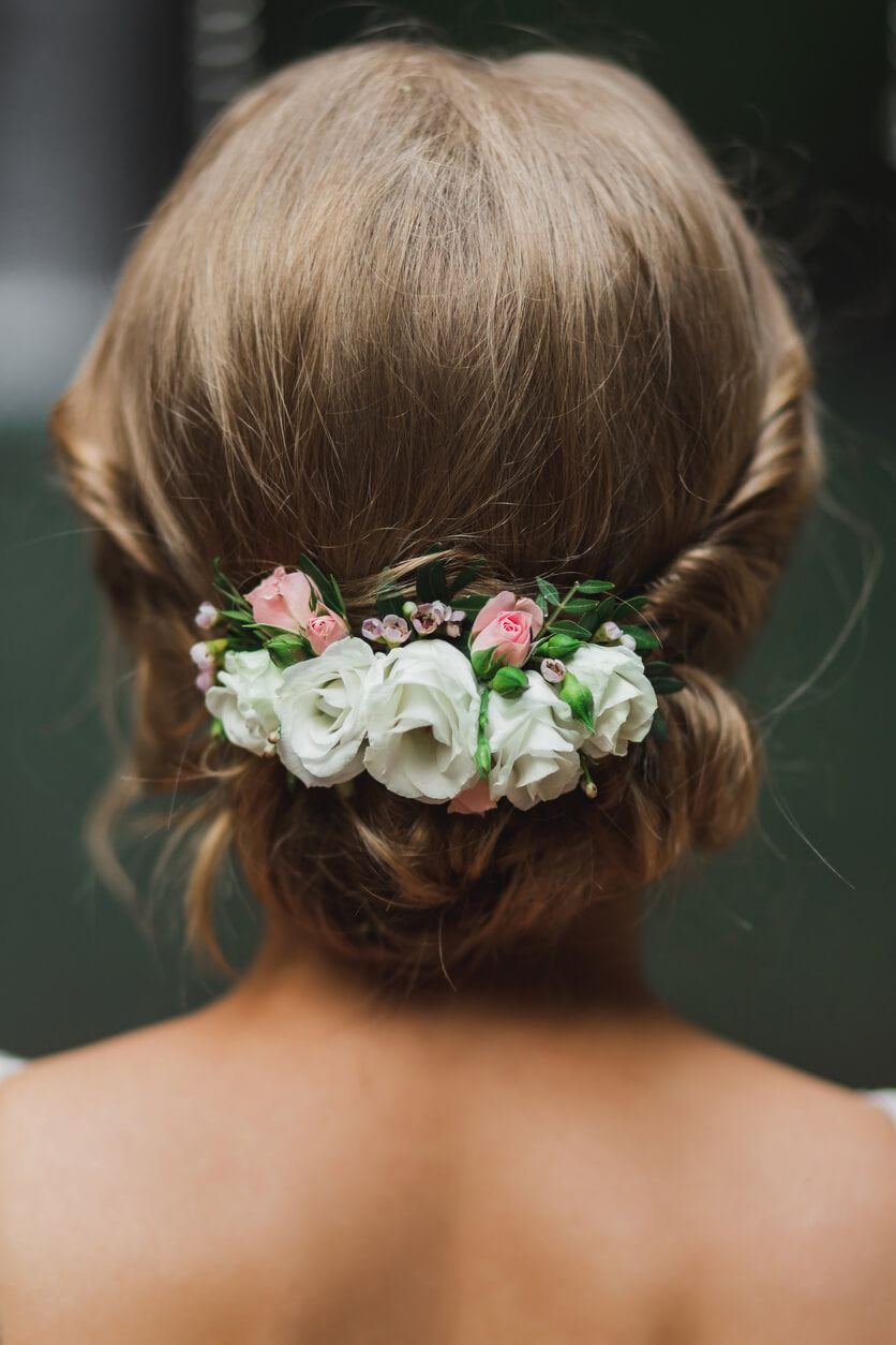 Romantic bridal hairstyle chignon with roses.
