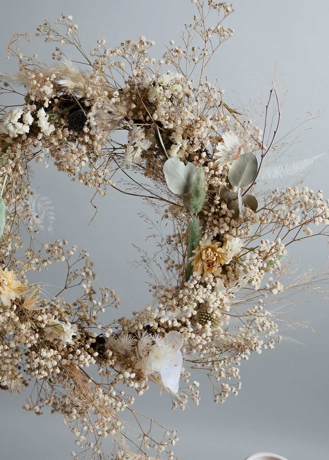 Dried flower wreath with baby breath, pine cones, and eucalyptus.