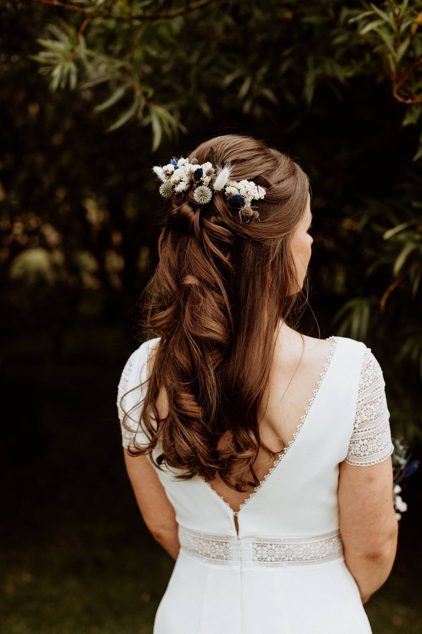 Hidden Botanics’ romantic half-up wedding hair with wildflowers.