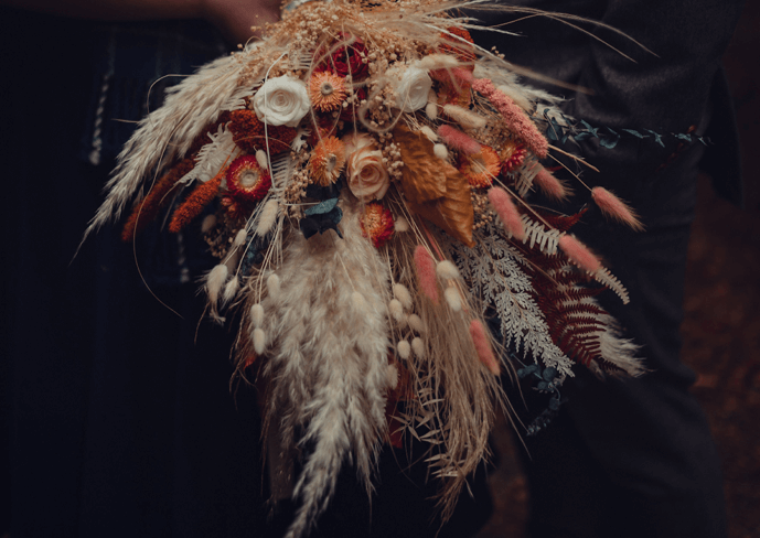 A cascading wedding bouquet from Hidden Botanics with a mix of dried and fresh flowers.