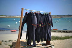 Hanging wetsuits drying in the sun at the beach