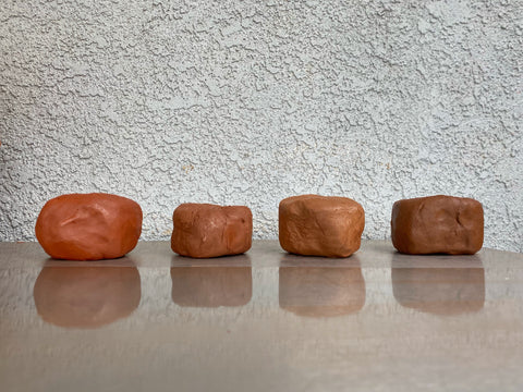 The different types of clay that Cheer uses to throw on the wheel for Dirtbag Ceramics.