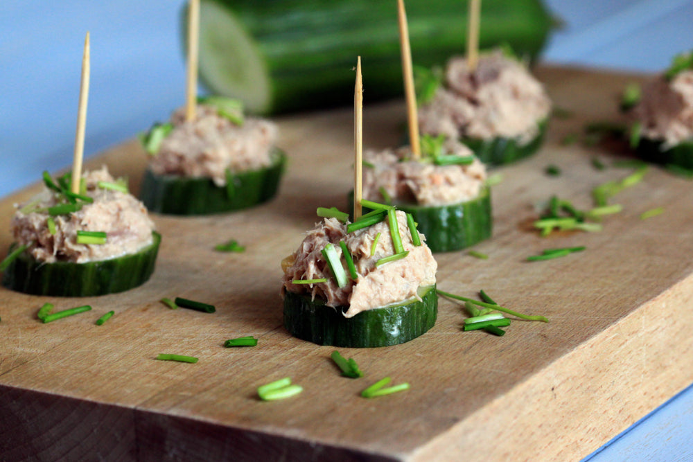 A tasty snack with cucumber and tuna. Party appetizer. Small sandwiches with cucumber and tuna paste.