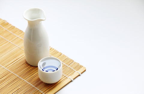  A bottle of sake and a sake cup.