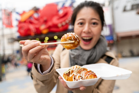 Woman eating takoyaki