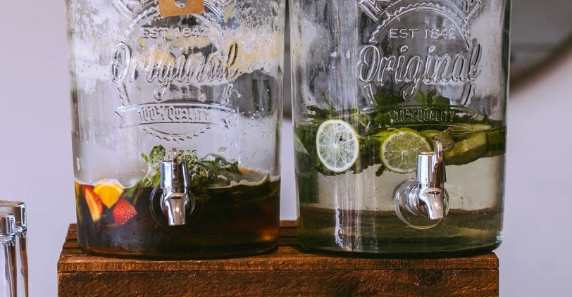 Large glass dispensers of sun tea