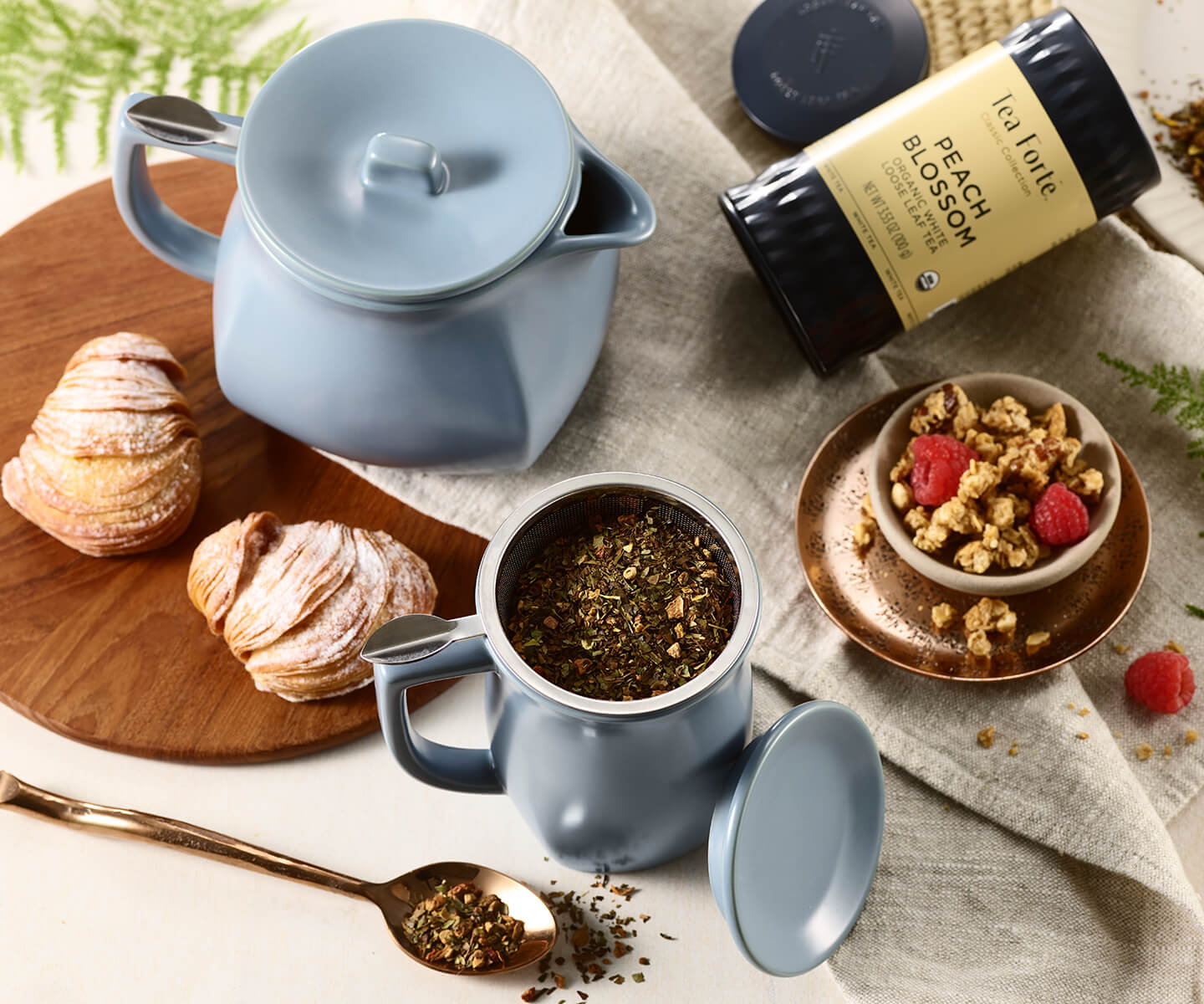 Fiore Teapot and Steeping Cup with loose tea and breakfast items