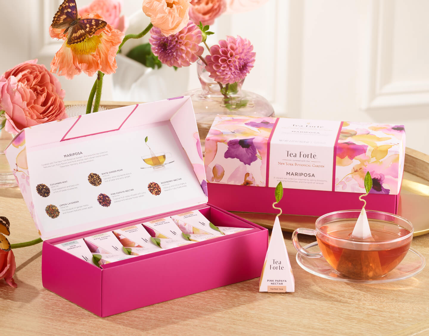 Mariposa Petite and Presentation Box, open and closed on table with a glass cup of tea