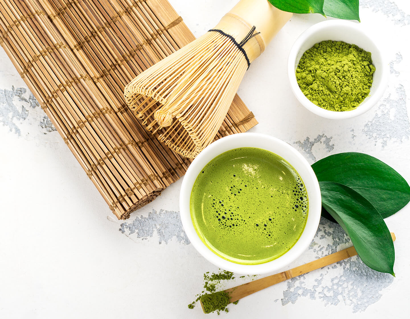 Matcha green tea on bamboos mats
