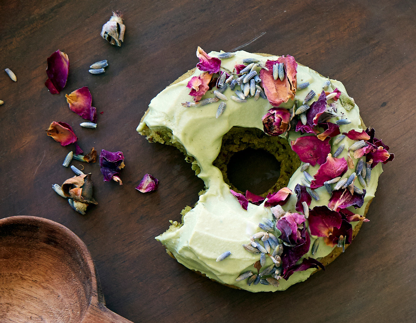 Matcha frosted donuts topped with dried, edible flowers.