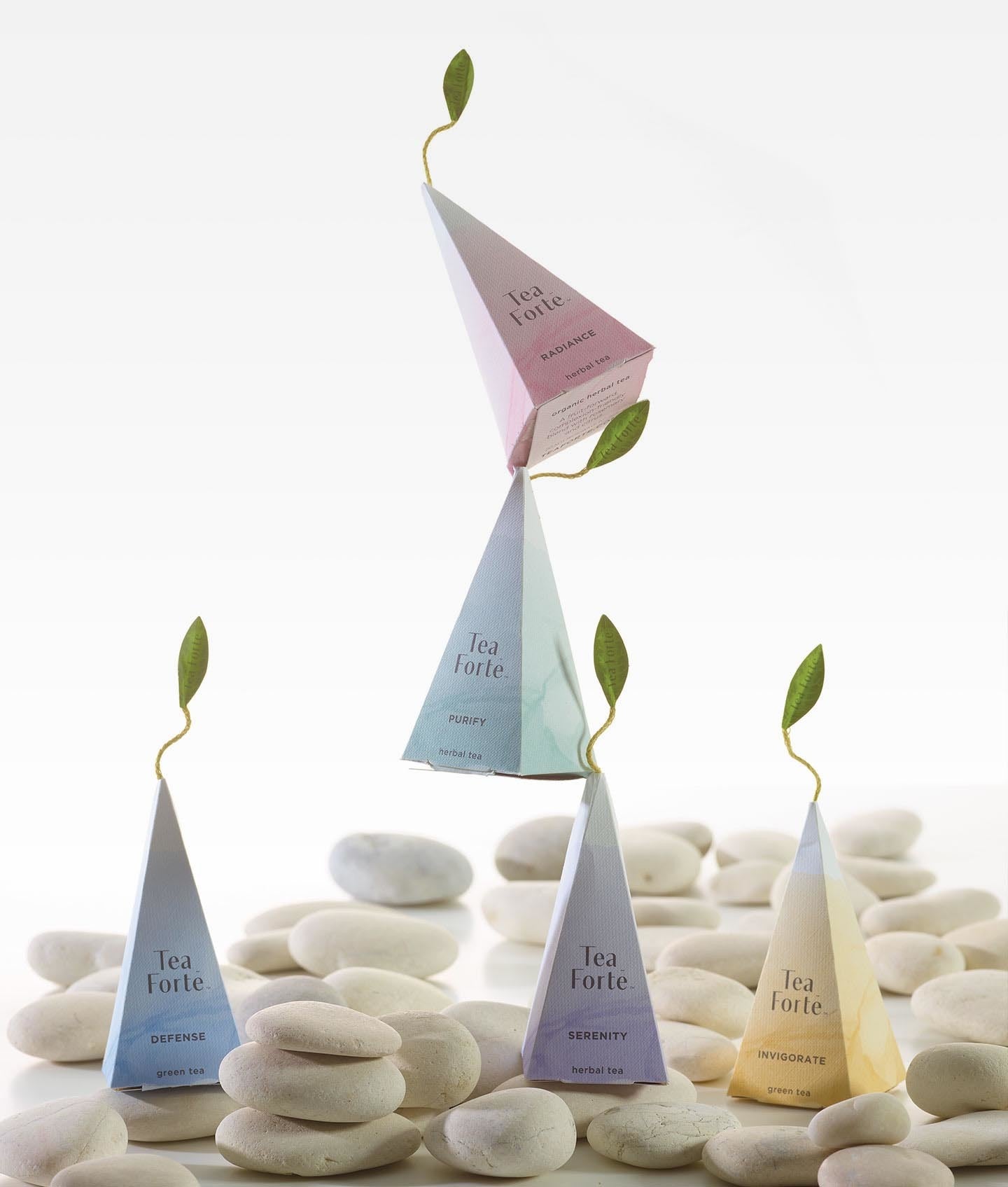 Balancing wellbeing pyramid infusers and smooth beach stones