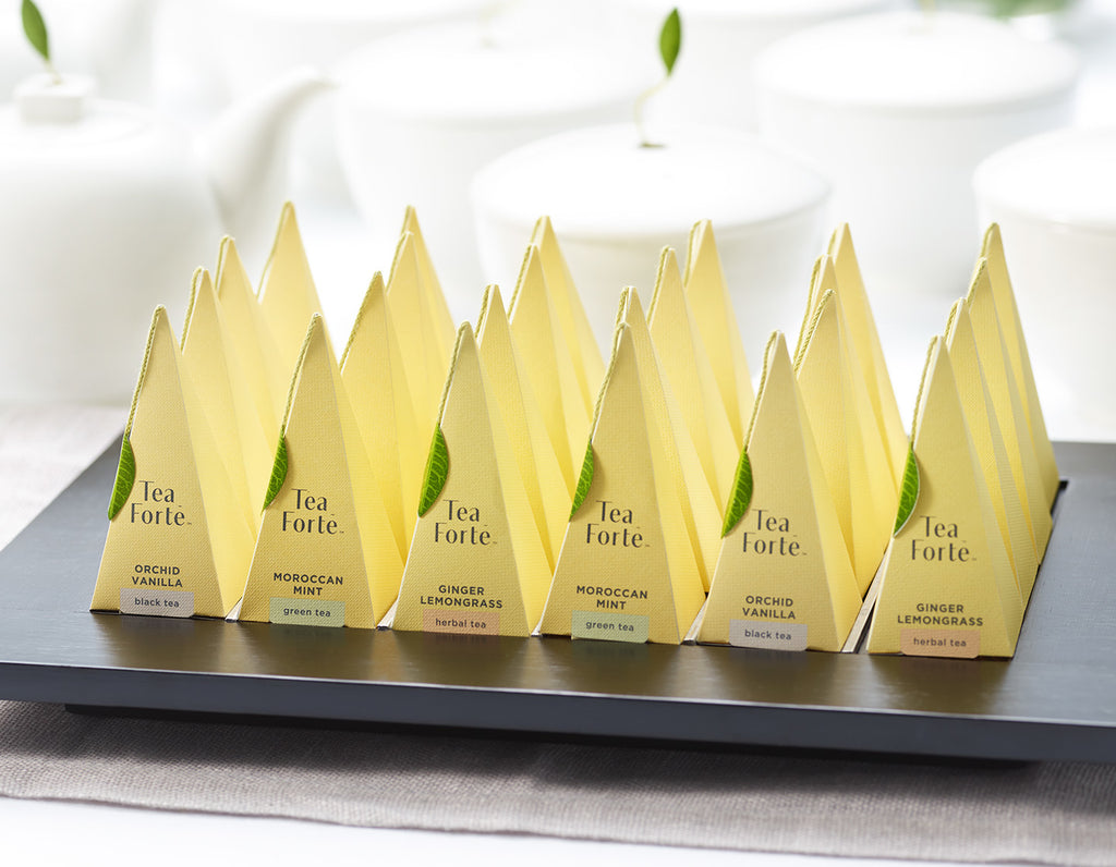 Pyramid tea infusers arranged on a black Presentation Tray.