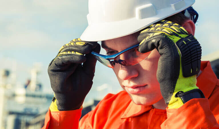 Worker putting on their safety glasses
