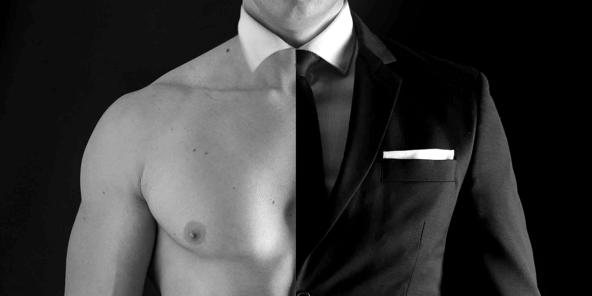 Monochrome image capturing the juxtaposition of a bare masculine torso and a formal suit, symbolizing Core Benefits Toowoomba's commitment to men's massage and wellness.