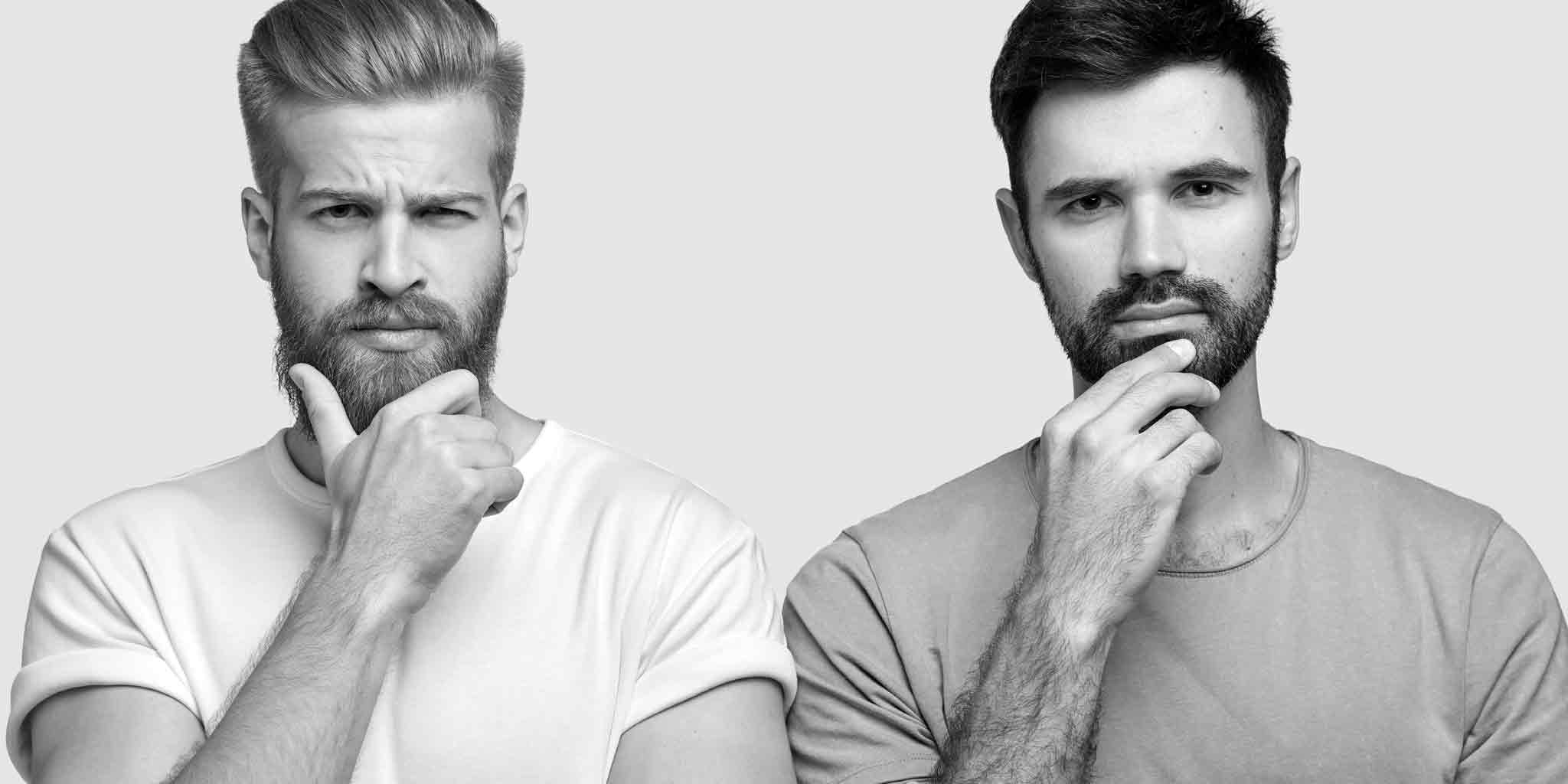 Black and white image featuring two men with beards and short hair, each in a thoughtful pose with one hand on their chin, possibly contemplating the common myths surrounding men's Brazilian waxing.