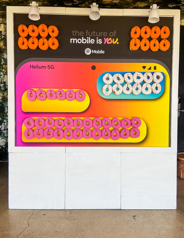 Custom doughnut wall for product launch at Helium Mobile of text exchange