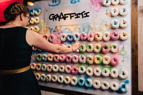 Woman Sprays Graffiti Donut Wall Interactive Austin Texas